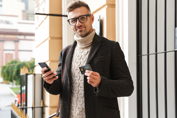 Canvas Print - Handsome man wearing a coat walking