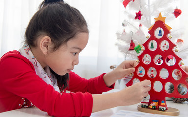 Wall Mural - Christmas and new year theme young asian woman decorating Christmas tree..