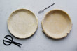 © The Picture Pantry - Raw uncooked pie crust in baking pan for two pies on concrete background