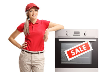 Poster - Female sales manager standing next to an electrcal oven on sale