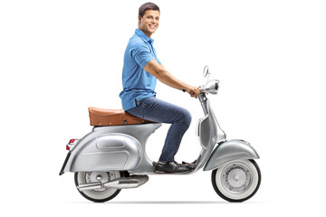 Poster - Full length shot of a happy young man riding a vintage scooter and looking at the camera