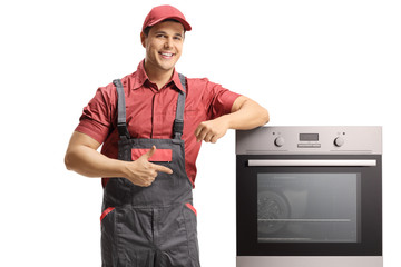 Wall Mural - Repairman pointing to an electric oven