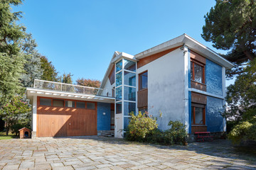 Old villa with garden in a sunny summer day, clear blue sky in Italy