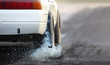 © toa555 - Drag racing car burns rubber off its tires in preparation for the race