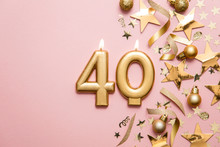 Number 40 Gold Celebration Candle On Star And Glitter Background