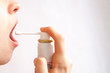 © Карина Желнина - spray to treat throat in hand on white background