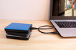 © damrong - Many Colorful Portable external hard Drives USB3.0 connect to laptop computer on wooden background