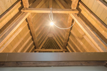 Wall Mural - attic, wooden beams in old loft ,roof before construction with lights on