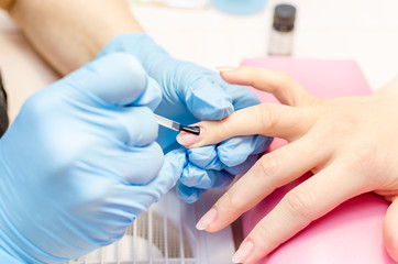  Manicure, cleaning, polishing and painting nails in the salon