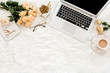 © K.Decor - Female workspace with laptop, roses flowers bouquet, golden accessories, diary, computer, glasses on white background. Flat lay women's office desk. Top view feminine background.