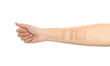 Woman testing different shades of liquid foundation on her hand against white background, closeup