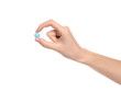 © New Africa - Woman holding color pill on white background, closeup