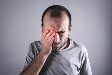 Canvas Print - Caucasian man with eye pain. Eye disease