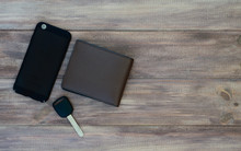Top View Of Man Set. Wallet, Car Key And Smartphone On Wooden Background. Top View With Copy Space.