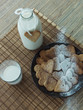 cup of milk and cookies on wooden table