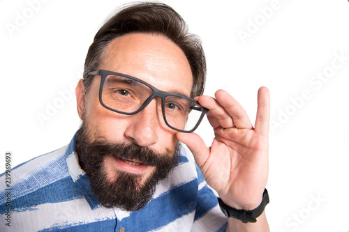 Valokuva Close up of intelligent bearded man looking at you through glasses