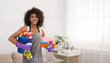 © Prostock-studio - Smiling black woman posing with cleaning supplies