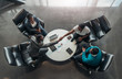 © JonoErasmus - Group of African business people sitting and discussing statistics during a sit down meeting taking from above. Two colleagues are shaking hands