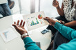 © JonoErasmus - African business man sharing information from a graph during a meeting