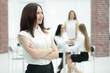 © yurolaitsalbert - portrait of confident young business woman on office background