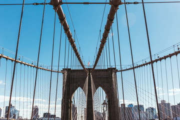 brooklyn bridge on blue sky and manhattan on background, new york, usa