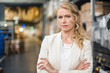 © Westend61 - Portrait of confident woman in factory storehouse