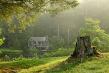 Old Watermill Building In Lush Forest On Dewy Morning