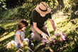© Yakobchuk Olena - Little girl helping her grandfather working in garden