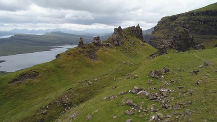 Wall Mural - drone flight over rugged mountains reveals lakes and panoramic overview of skye island, tourism trav