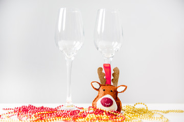 two wine glasses with a garland on a table