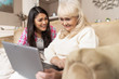 © Svyatoslav Lypynskyy - Smiling daughter teaches her senior mother how to use laptop