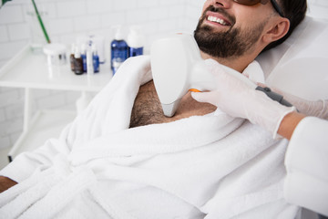 Close up of hand with laser hair removal on hairy male chest