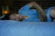 © TheVisualsYouNeed - depressed beautiful Asian Chinese girl suffering menstruation and period pain feeling sick in bed at night with stomach ache and cramp as woman in painful menstrual cycle