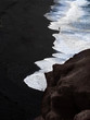 Black beach in the Lanzarote island. Silhouette of a people, White waves in the blck rocks 