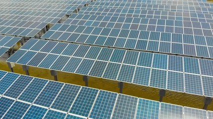 Wall Mural - Aerial view over solar panel for generate electricity in solar energy farm, shot by 4K resolution drone.	