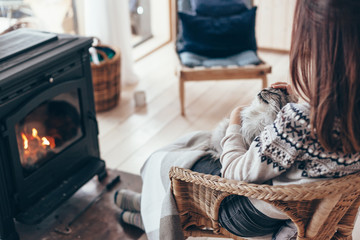 Wall Mural - Human with cat relaxing by the fire place