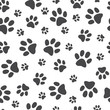 © sabelskaya - Vector illustration animal paw track seamless pattern - backdrop with monochrome silhouettes of cat or dog footprint. Cute texture of black print of kitten or puppy trace shapes.