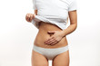© alfa27 - Stomach pain or menstrual pain. Cropped view of caucasian slim woman with palm on belly, showing pains in stomach area or gynecological problems. Women Health
