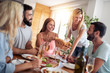 © ivanko80 - Smiling friends having lunch together at home