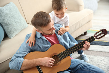 Canvas Print - Father playing guitar for his son at home