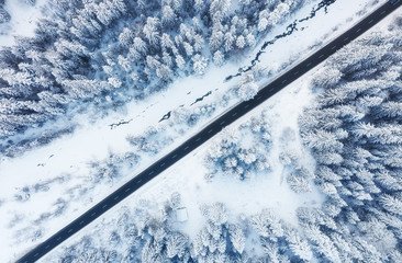 Wall Mural - aerial view on the road and forest at the winter time. natural winter landscape from air. forest und