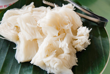 thai rice noodle / close up of white rice noodle for curry soup in local food noodle on banana leaf