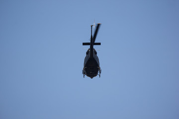 Helicopter flying in the blue sky