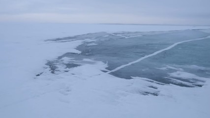 Wall Mural - a snowstorm on the surface of the frozen sea, the wind carries snowflakes through the ice floe.
