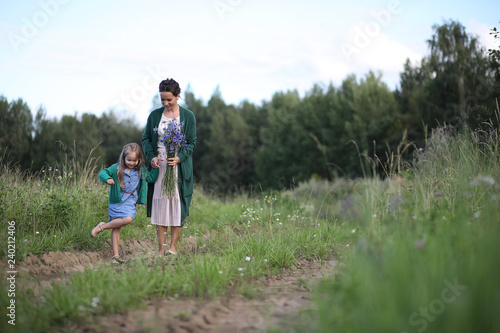 Fotografia, Obraz Mother with daughter walking on a road
