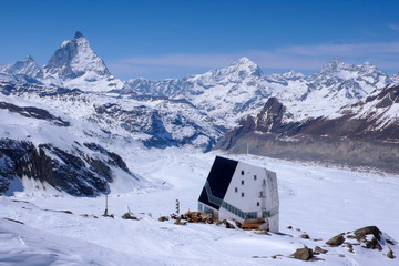 Canvas Print - horizontal view of the Monte Rosa mountain hut with the famous Matterhorn peak and surrounding winter landscape in the background