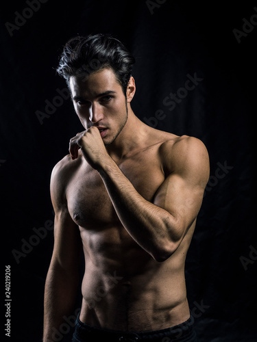 Fotografía Handsome muscular shirtless young man standing confident, front view, looking at