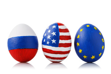 Wall Mural - Three Easter eggs painted in the colors of flags of Russia, America and the European Union isolated on a white background. Concept on theme of friendship between countries