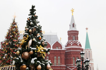 Wall Mural - New Year celebration in Russia, Christmas trees against the Moscow Kremlin. Russian winter holidays, festive decorations during snowfall, cold weather