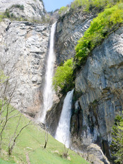 Fotomurales - two tall waterfalls in the mountains of Switzerland above Walensee